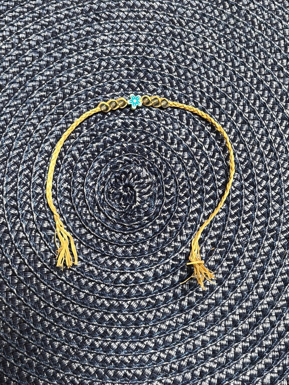 Gold-Tone Braided Bracelet with Blue Flower Accent